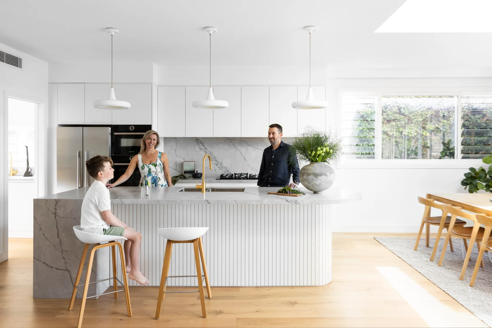 A relaxed retired couple enjoying coffee in the beautiful kitchen of their new luxury home financed with an Asset-Qualifier Loan from Doos Mortgage